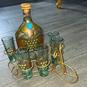 Vintage estate decorative rum bottle and 6 shot glasses on bike bottle holder